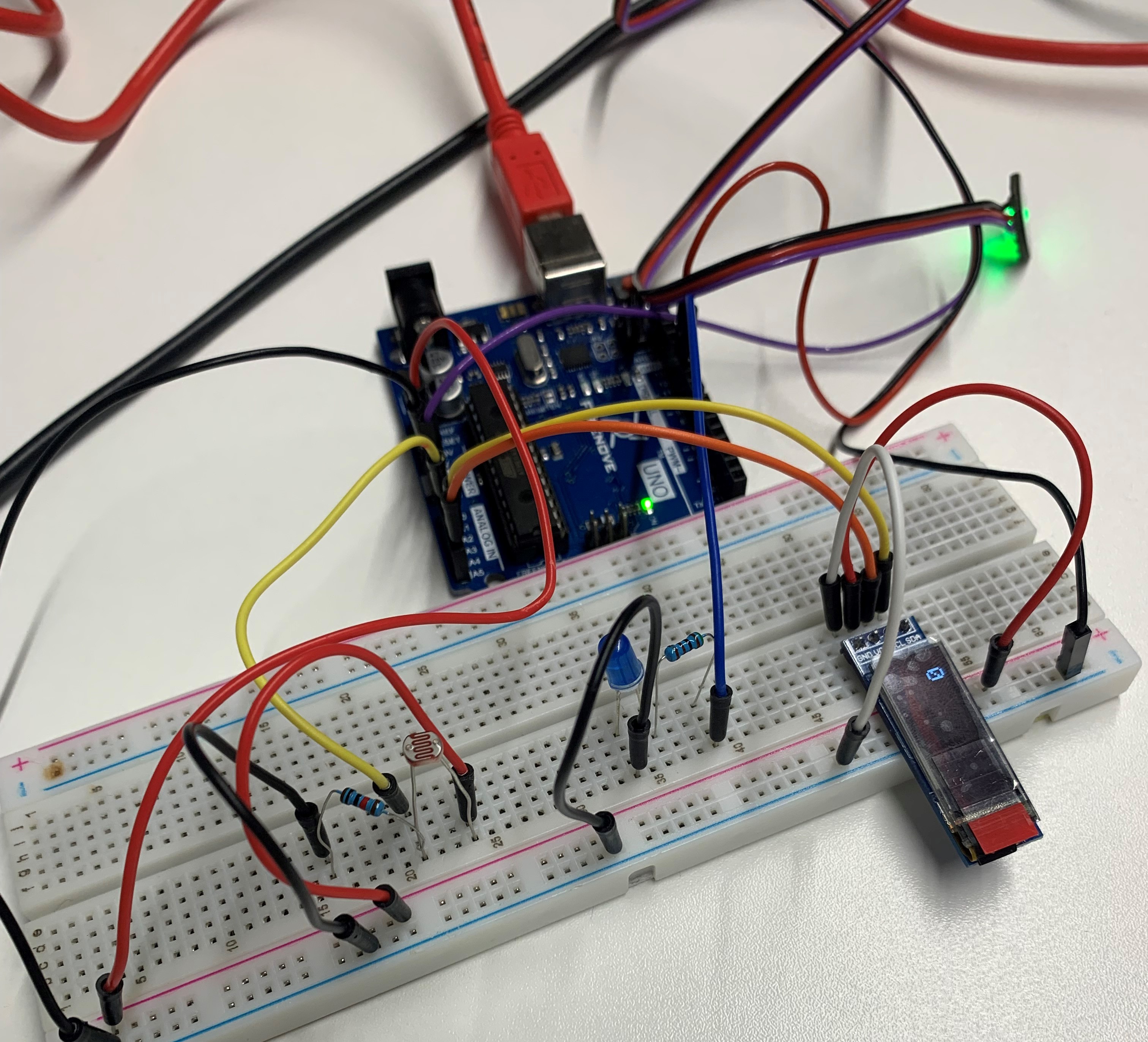 breadboard with light and pulse sensor attached